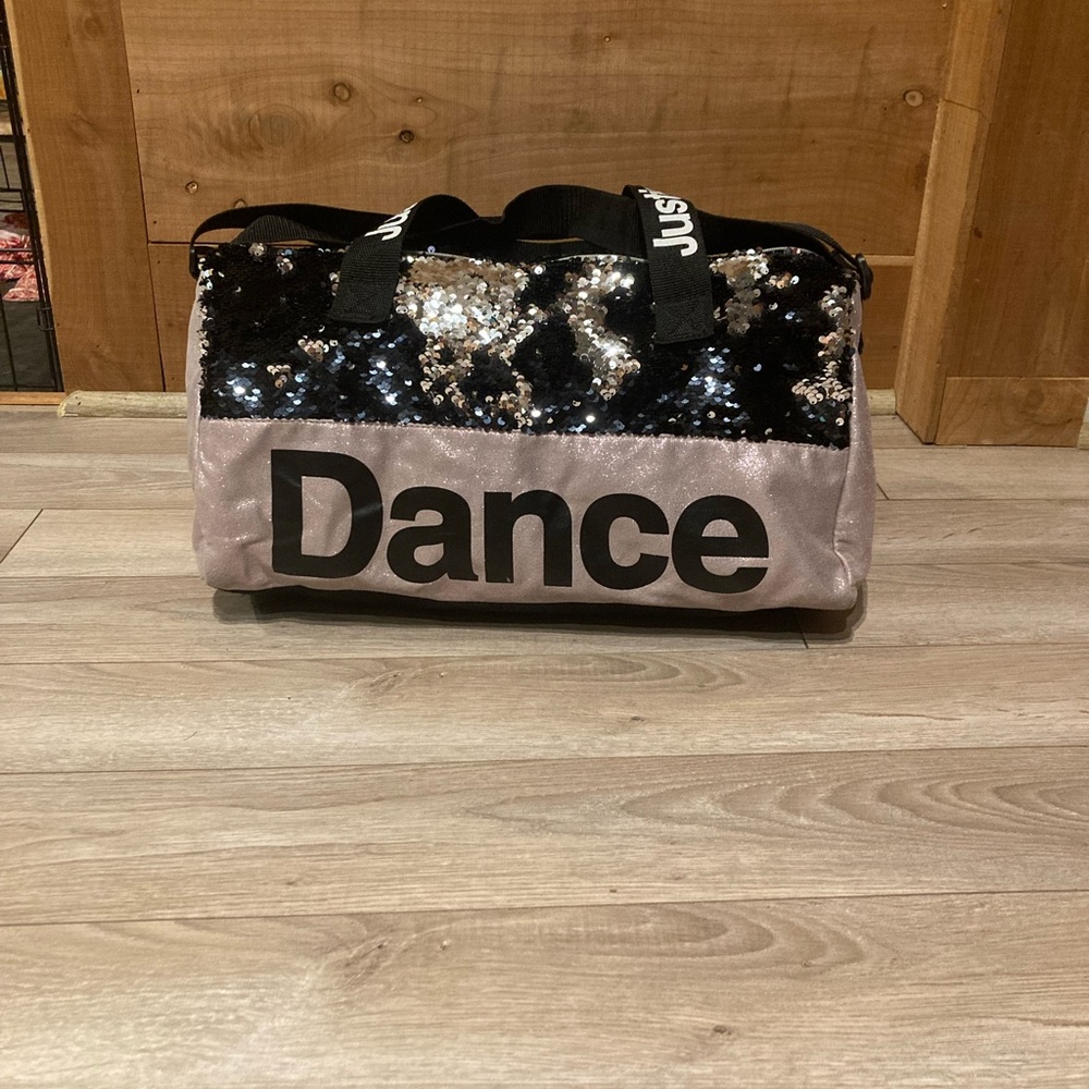 A black and purple justice dance bag